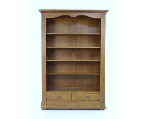 A modern French oak veneered freestanding bookcase, with four adjustable shelves and two drawers below with metal ring handle