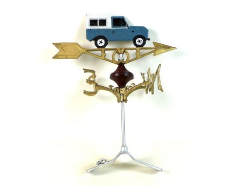 A modern cast iron weather vane, painted metal, with Land Rover Defender shaped ornament, and gold coloured directionals, sil