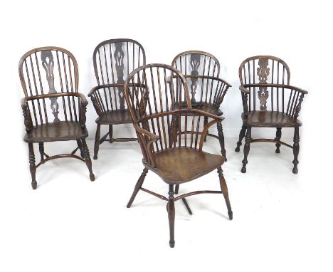 A group of five Windsor armchairs, comprising a late 18th century elm and oak Windsor stamped 'W. P. Clapson', with crook arm