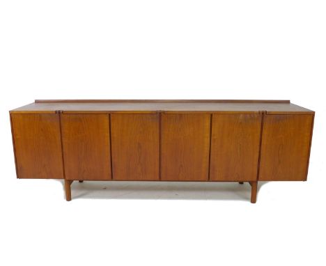 A British teak sideboard, Robert Heritage for Archie Shine, of long low form with small shaped upstand to the back edge, the 