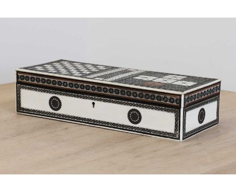 An Anglo-Indian ivory-inlaid travelling games box,mid-19th century, Calcutta, the top profusely inlaid with boards for chess,