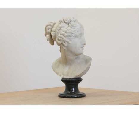 After the antique, a carved marble bust of Diana,20th century, raised on a turned green marble socle,34cm high Condition repo