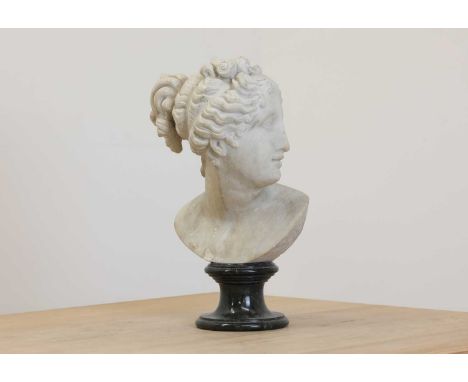 After the antique, a carved marble bust of Diana,20th century, raised on a turned green marble socle,34cm high Condition repo