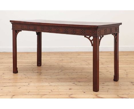 A George lll and later mahogany serving table,the front and side friezes with blind fretwork and pierced corner brackets, on 