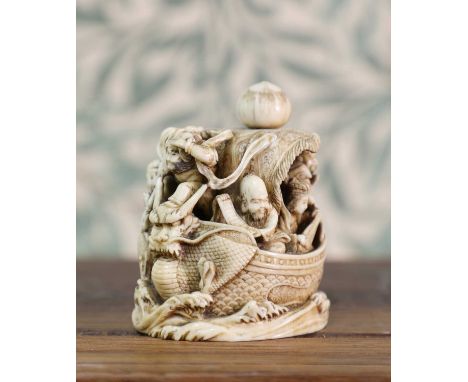 An ivory okimono,Meiji period (1868-1912), Japanese, deeply carved with Seven Gods of Fortune on the Takarabune (Treasure Shi