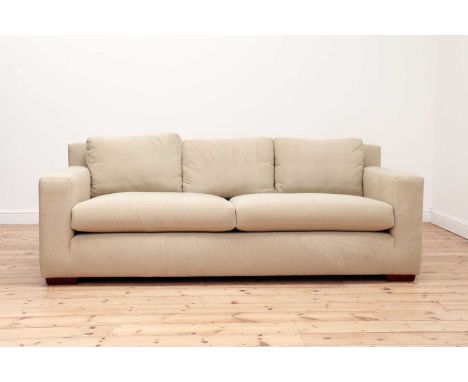 A large two-seater settee,20th century, with oatmeal upholstery and on short block legs,214cm wide102cm deep75cm highProvenan