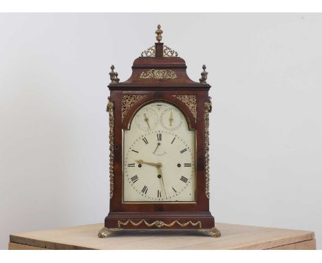 A George III musical table clock,c.1800, the mahogany case surmounted by brass urn finials, with gilt brass handles to either