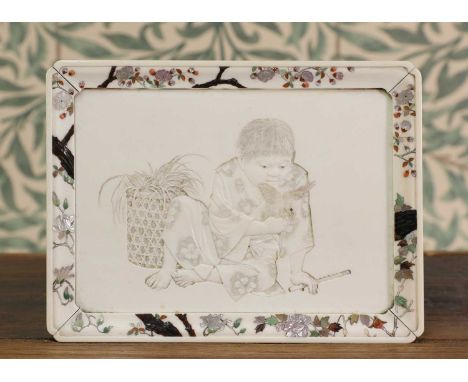 A Shibayama-style inlaid ivory tray, Meiji period (1868-1912), Japanese, carved to the centre with a boy and a bird, the rais