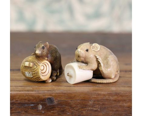 An ivory okimono,Meiji period (1868-1912), Japanese, carved as a mouse hovering over a candle, signed 'Seimin', 4.5cm long,to