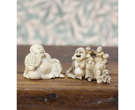 An ivory netsuke,Meiji period (1868-1912), Japanese, carved with Hotei seated wearing a loose robe exposing his bare belly, w