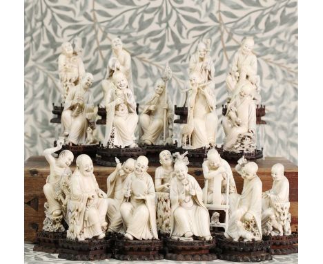 A set of eighteen carved ivory figures,19th century, Chinese, on wooden stands, described as the 'Disciples of Lohan', each p