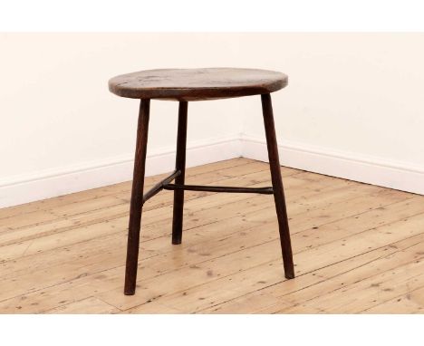 An elm cricket table,probably late 18th/early 19th century, the circular top above three legs with a joined 'T' stretcher,57c