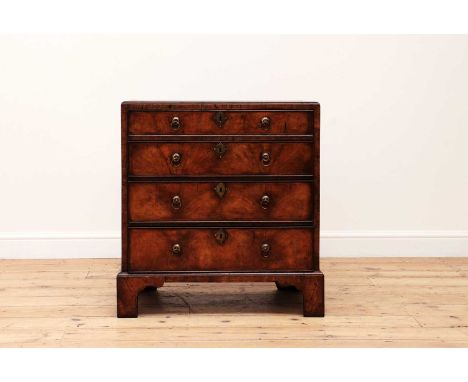 A small George I-style walnut chest of drawers,18th century and later, the crossbanded and quarter-veneered caddy top over fo