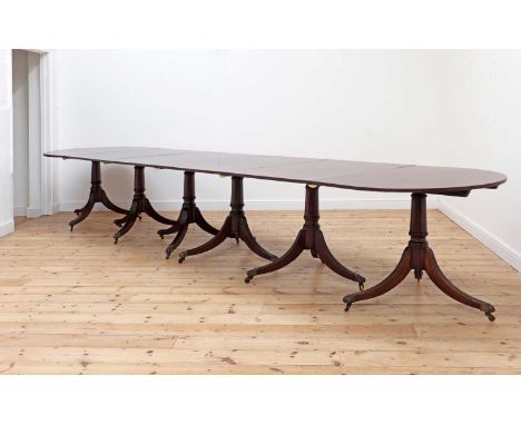 A George III-style mahogany six-pillar dining table,c.1900 and later, with four additional leaves, on barrel turned columns, 