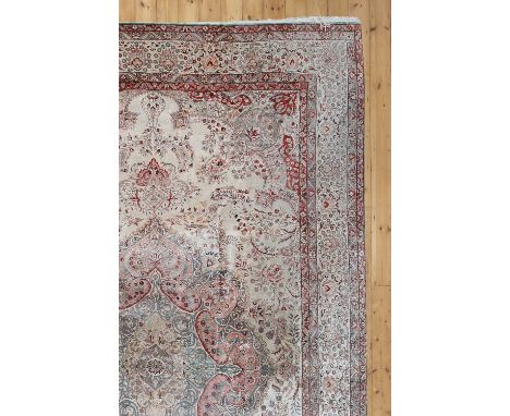 A Persian silk carpet,late 20th century, Isfahan, with a central panel and scrolling flowers, with a border of flowers, withi