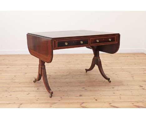 A Regency rosewood sofa table,the rounded rectangular top banded with tulipwood and strung with satinwood, above a frieze set