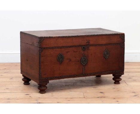 A walnut and studded trunk,Spanish, with studded detail and on ring-turned supports,76cm wide38cm deep44cm highProvenance: Br