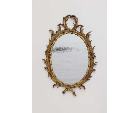 A George III giltwood pier glass,third quarter of the 18th century, after a design by John Linnell, the oval mercurial plate 