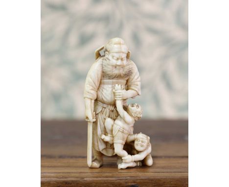 An ivory netsuke,Meiji period (1868-1912), Japanese, carved with Shoki standing with a sword in his right hand, grasping an o