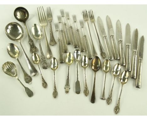 A group of silver flatware.