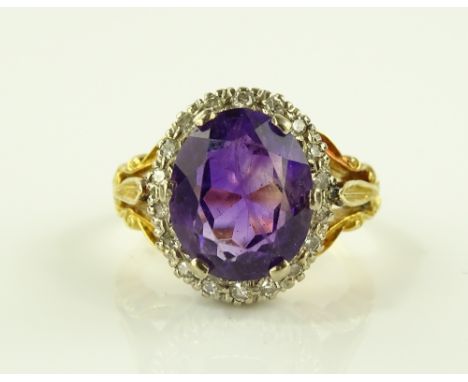 An 18ct gold amethyst and diamond cluster ring, setting height 15mm, size N.