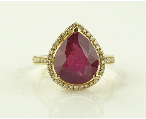 A 14ct gold pear-cut ruby and diamond cluster ring, ruby approx. 5.86cts, total diamond content approx. 0.4cts, size M.