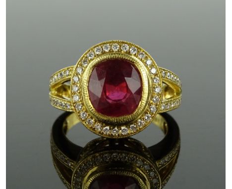 An 18ct gold ruby and diamond cluster ring, oval-cut ruby approx. 3cts, total diamond content approx. 1ct, setting height 15m