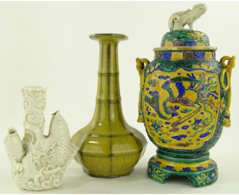 A Chinese ceramic jar and cover, relief exotic bird designs, height 27cm, a yellow glazed narrow necked vase and a blanc de c