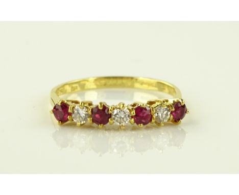 An 18ct gold 7 stone ruby and diamond ring, size L.