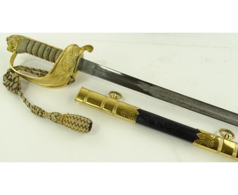 A Royal Navy Reserve Officer's dress sword, engraved blade with gilt brass hilt and shagreen grips, original brass mounted le