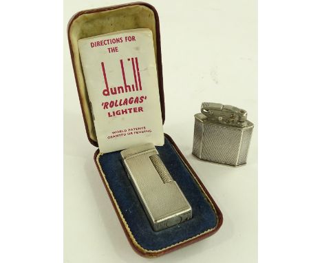 A cased Dunhill lighter and an Art Deco silver mounted pocket lighter, (2).