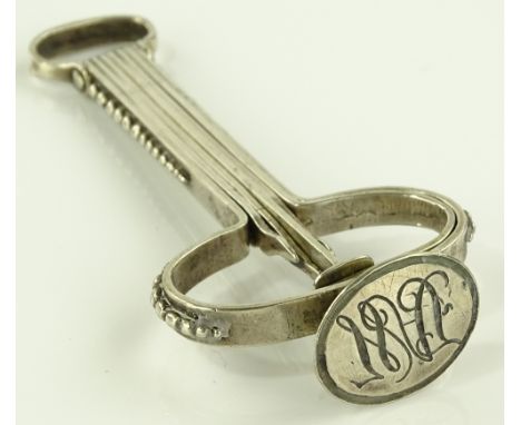 A Victorian unmarked white metal combination desk seal/pipe cleaner, length 9cm.