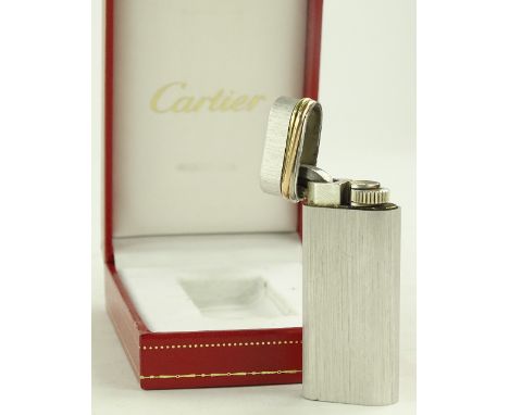 A Cartier gold and silver mounted pocket lighter, boxed.