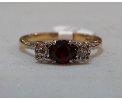 An 18ct gold garnet and diamond set ring, setting height 5mm, 3.8g, size R.