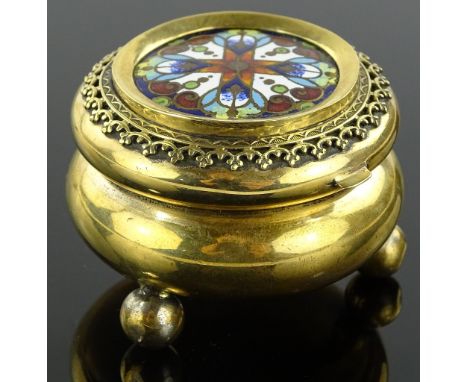 A small Victorian gilt brass trinket box with enamelled decorated lid, diameter 4.5cm.