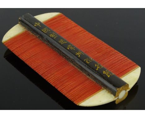 A 19th century Oriental ivory and lacquer comb, length 11cm.