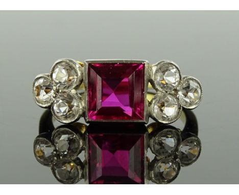 An 18ct gold and platinum square-cut synthetic ruby and white sapphire set ring, setting width 21mm, size P.