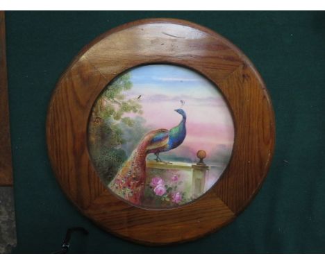 VICTORIAN HANDPAINTED CERAMIC CIRCULAR PLAQUE DEPICTING A PEACOCK, SIGNED, DIAMETER APPROXIMATELY 26cm HIGH  