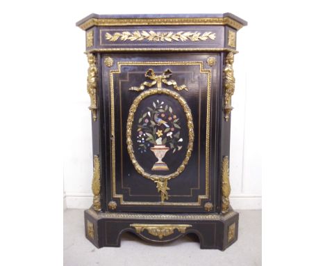 A mid 19thC French ebonised cabinet with ormolu mounts, having a black marble top, over a pietra dura panelled door featuring