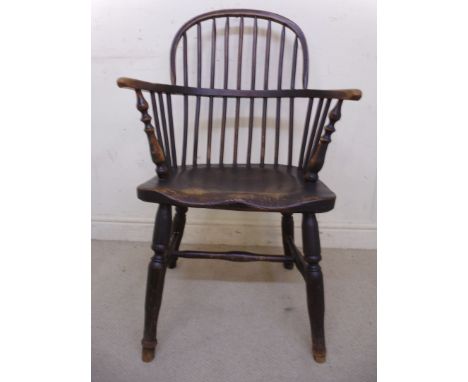 A mid 19thC beech, ash and elm framed Windsor chair, having a hoop and stick back, curved, level arms and a solid, moulded se