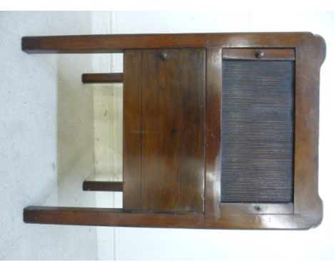 A George III mahogany night commode, having a galleried top with opposing cut-out handles, over a tambour front and door, rai