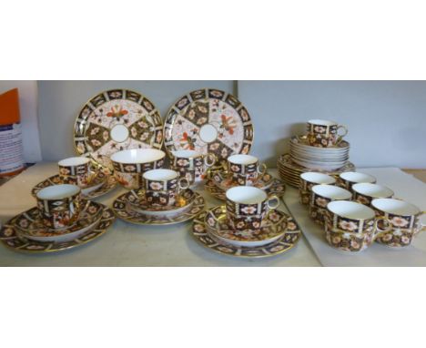 A Royal Crown Derby china tea set, decorated in the Imari palette  comprising twelve cups, saucers and side plates, a pair of