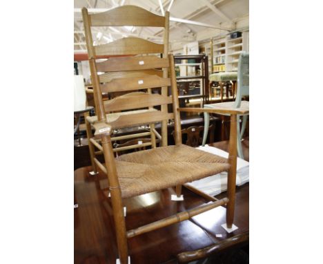 An ash ladder back chair with rush seat and a smaller ash child's chair similar.