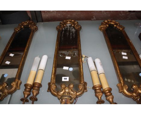 Three gilt composition twin light girandoles, 77cm long