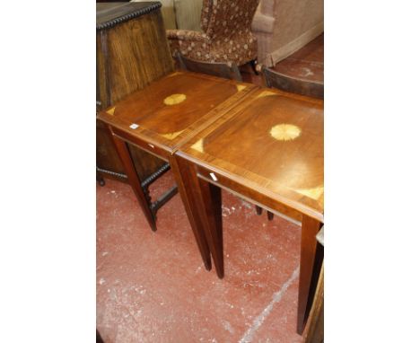 A pair of mahogany lamp tables with satinwood spandrel to the center.