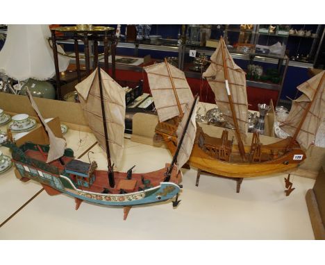 Two scale model wooden junks, one with hand painted decoration, both 57cm long approx.