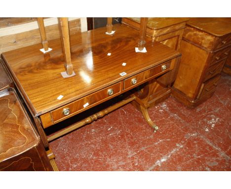 A Regency style mahogany sofa table on lyre end supports.