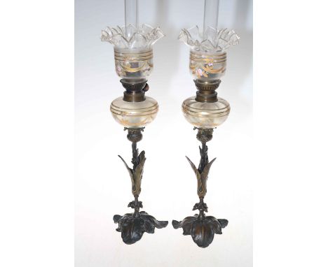 Pair of French leaf design metal based oil lamps with enamel and gilt decorated reservoir and shades, circa 1900.