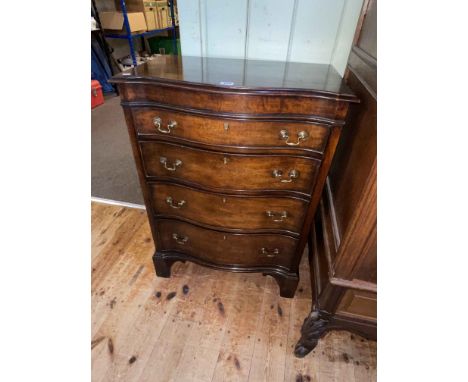 Mahogany serpentine front chest, the lid enclosing a mirror and compartments above three long drawers on bracket feet, 83.5cm