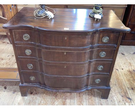 Mahogany shaped serpentine front chest of four long drawers on bracket feet, 74cm by 87cm by 49cm.